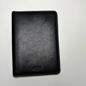 Coach black leather holder. 5” x 7”. White stitching. Rarely used.